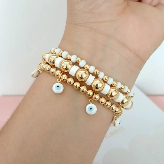 Set de tres pulseras ojitos blancos