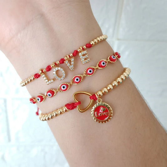 Pulsera roja love, ojitos y medalla love (piezas por separado)